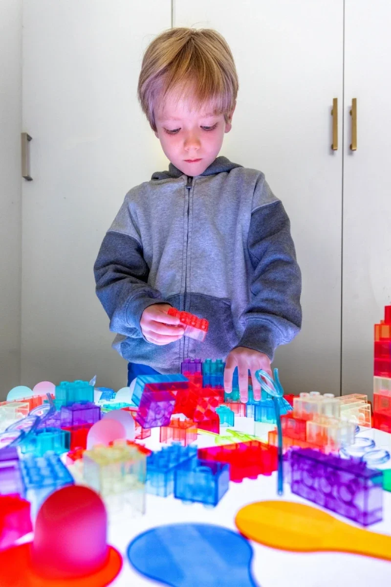Child exploring colors with pipettes