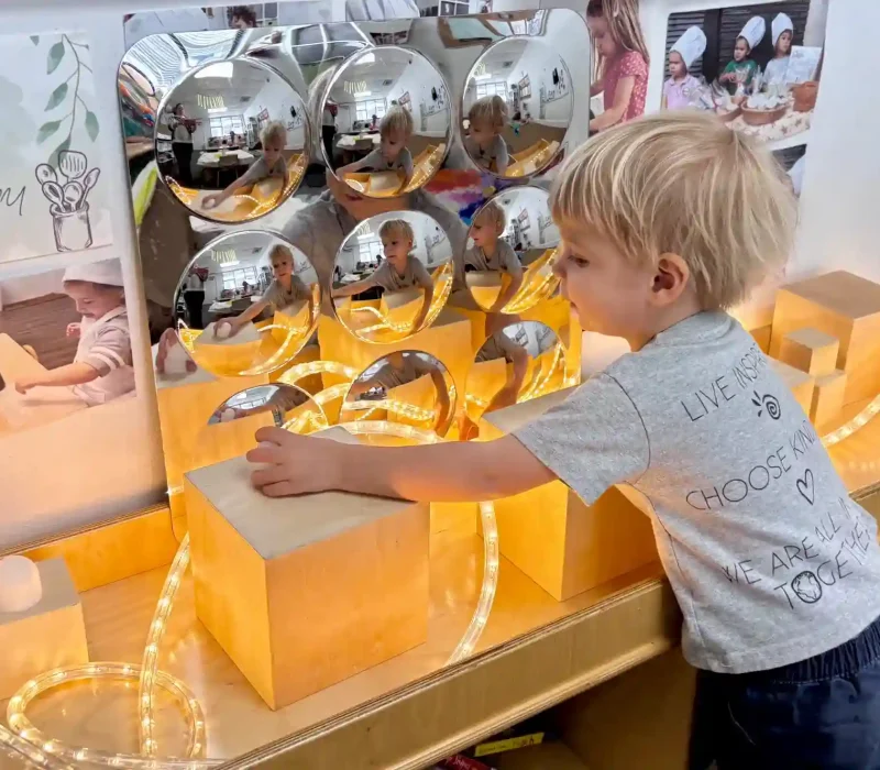 Child interacting with light and reflection